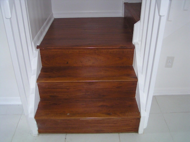 312 River Bluff Ln, Royal Palm Beach, FL 33411 - stairway featuring baseboards and tile patterned flooring