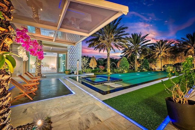 exterior space featuring an outdoor pool, a yard, and an in ground hot tub
