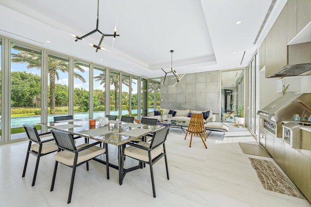 sunroom featuring an inviting chandelier