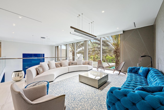 living area with a wealth of natural light, expansive windows, and recessed lighting