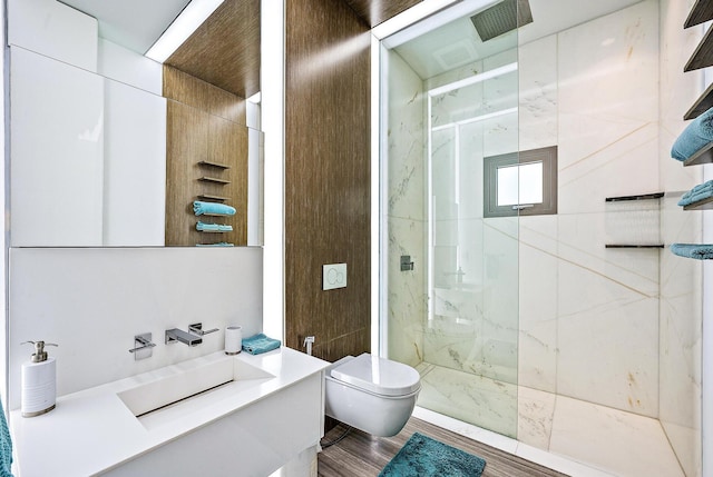 full bathroom featuring toilet, vanity, and a marble finish shower