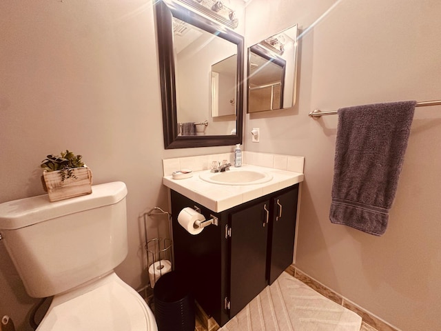 bathroom featuring toilet and vanity