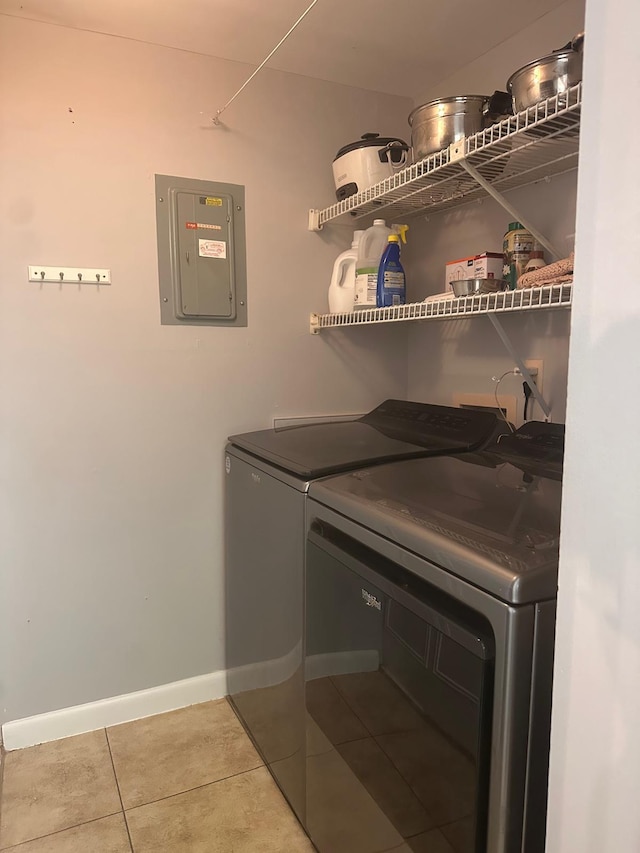 laundry room with independent washer and dryer, tile patterned floors, electric panel, and baseboards