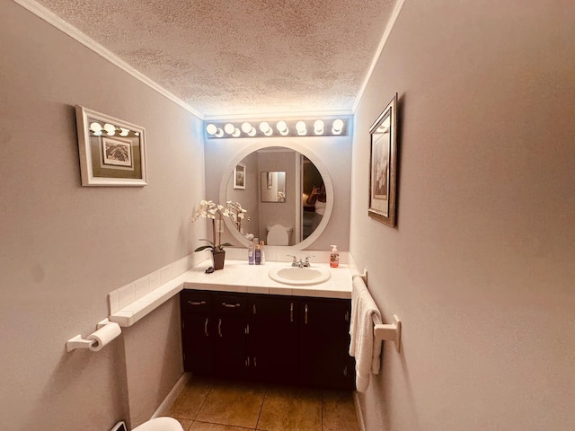 bathroom featuring a textured ceiling, tile patterned flooring, vanity, and crown molding