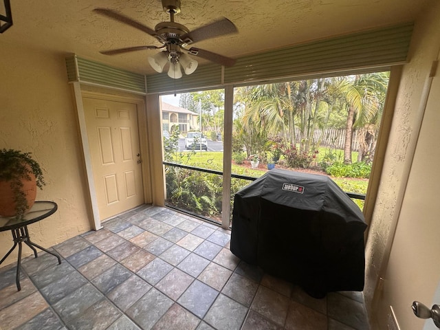 sunroom / solarium featuring ceiling fan