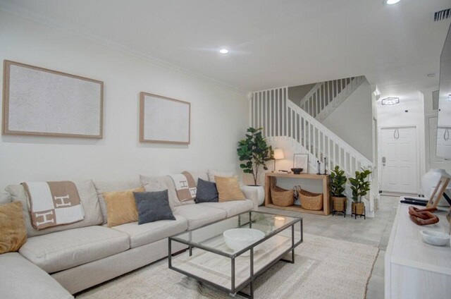 living room featuring crown molding, recessed lighting, visible vents, and stairway