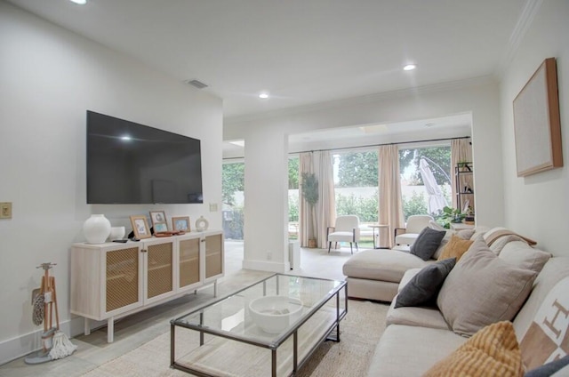 living room with ornamental molding, visible vents, and recessed lighting