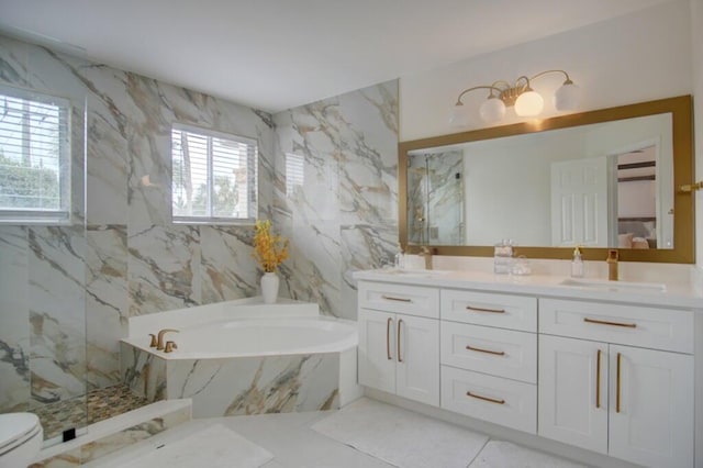full bathroom with a sink, double vanity, a marble finish shower, and a garden tub