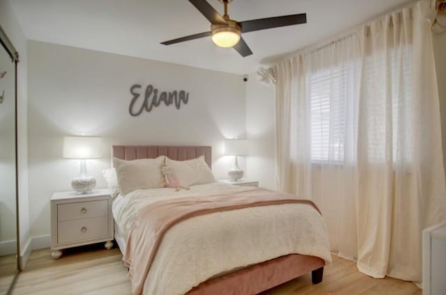 bedroom featuring light wood-type flooring and a ceiling fan