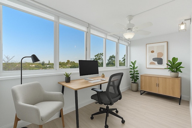 office with light wood-style flooring, baseboards, and ceiling fan