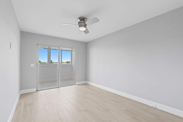 spare room with baseboards, a ceiling fan, and light wood-style floors