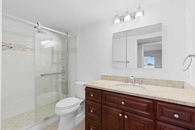 full bath featuring toilet, a stall shower, and vanity