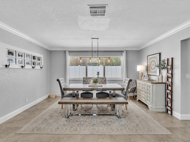 dining room with baseboards, crown molding, a textured ceiling, and visible vents