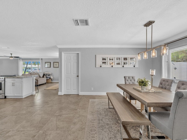 dining space featuring a ceiling fan, crown molding, visible vents, and a healthy amount of sunlight