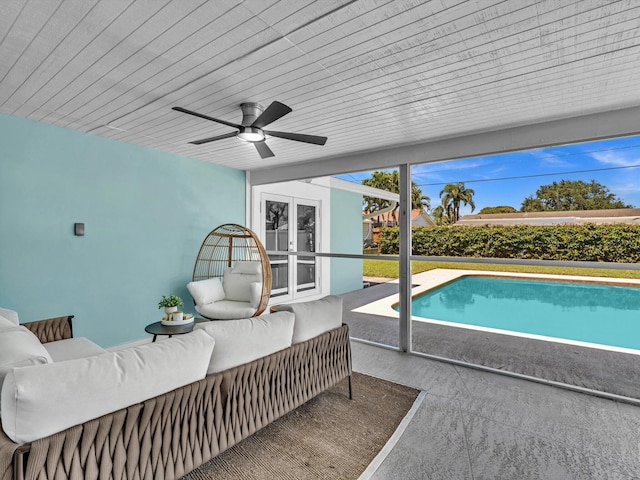 view of swimming pool with french doors, a fenced in pool, a patio area, ceiling fan, and an outdoor hangout area