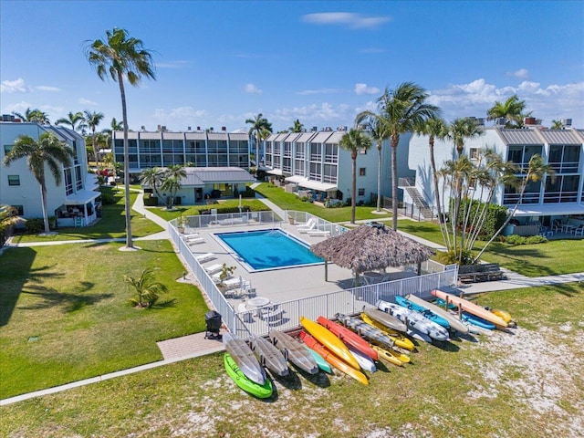 community pool with a lawn and fence