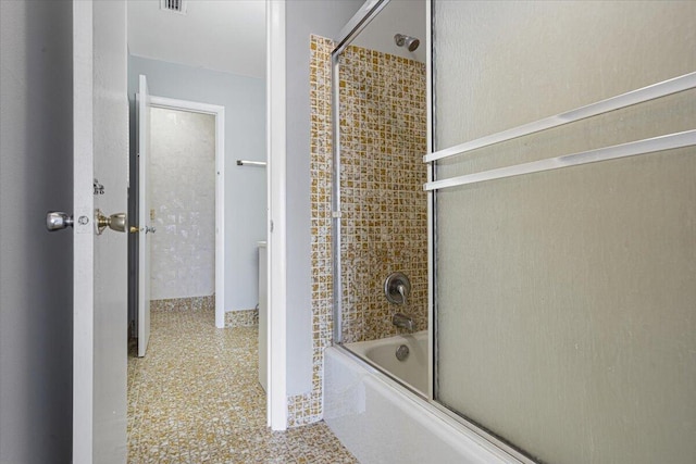 bathroom with enclosed tub / shower combo and visible vents
