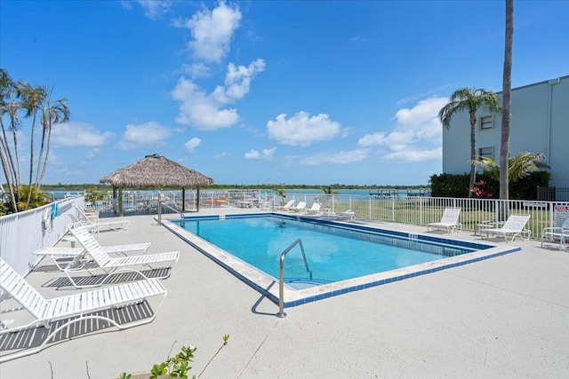 community pool featuring a gazebo, a patio area, and fence