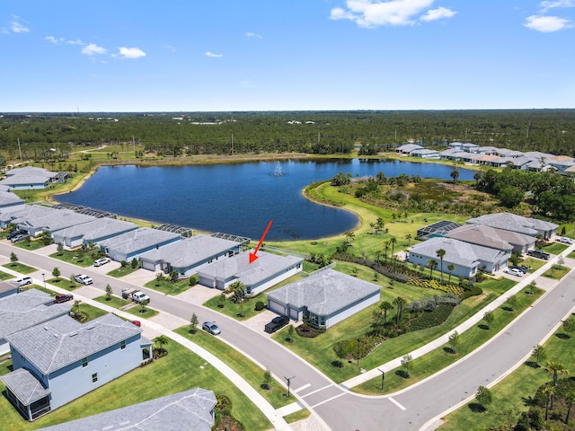 9891 SW Legacy Dr, Stuart, FL 34997 - aerial perspective of suburban area featuring a nearby body of water and a heavily wooded area
