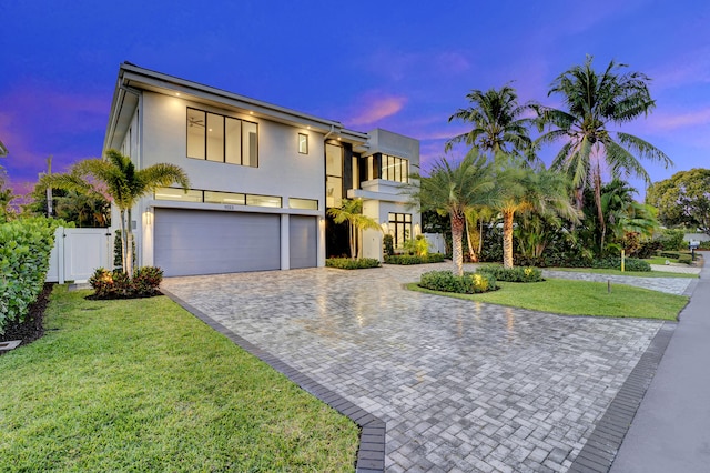 1133 NE 3rd Ave, Boca Raton, FL 33432 - view of front of house featuring fence, decorative driveway, a front yard, an attached garage, and stucco siding