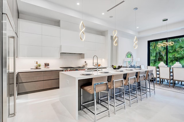 1133 NE 3rd Ave, Boca Raton, FL 33432 - kitchen featuring built in refrigerator, a breakfast bar, modern cabinets, and light countertops
