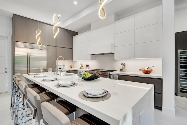 1133 NE 3rd Ave, Boca Raton, FL 33432 - kitchen with a sink, modern cabinets, a kitchen breakfast bar, high end appliances, and custom exhaust hood
