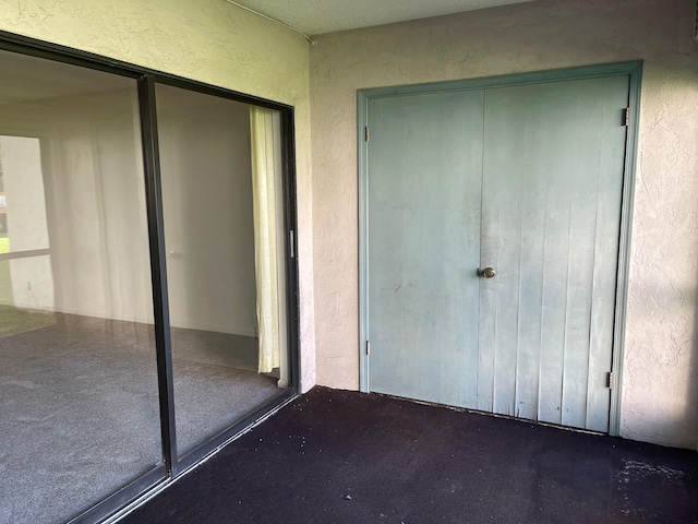 view of exterior entry with stucco siding