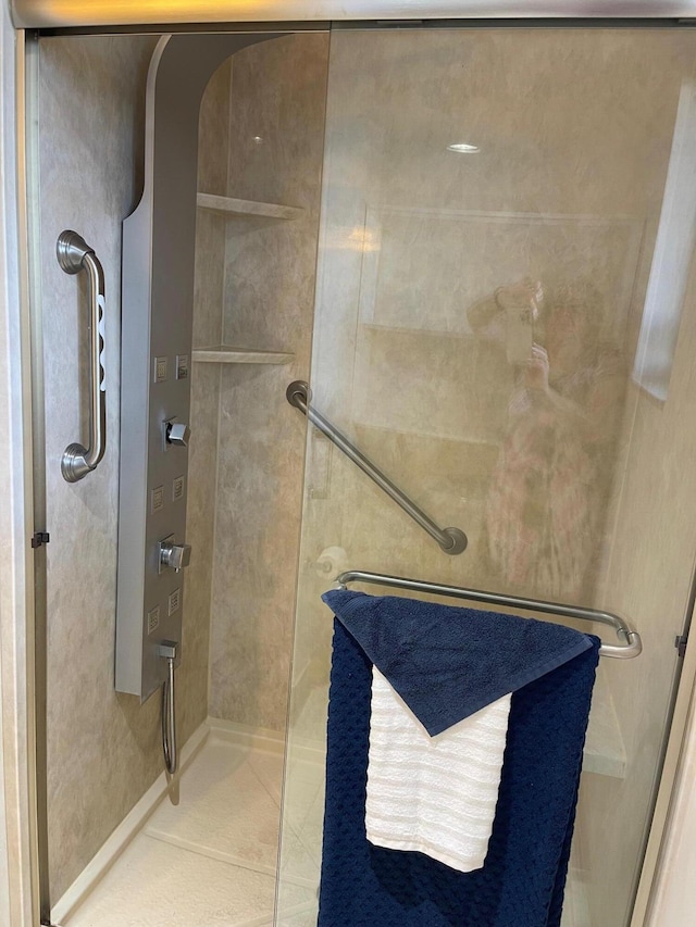 bathroom featuring a walk in shower and tile patterned floors