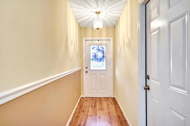 124 Mayfair Ln, Boynton Beach, FL 33426 - doorway to outside featuring light wood finished floors and a chandelier