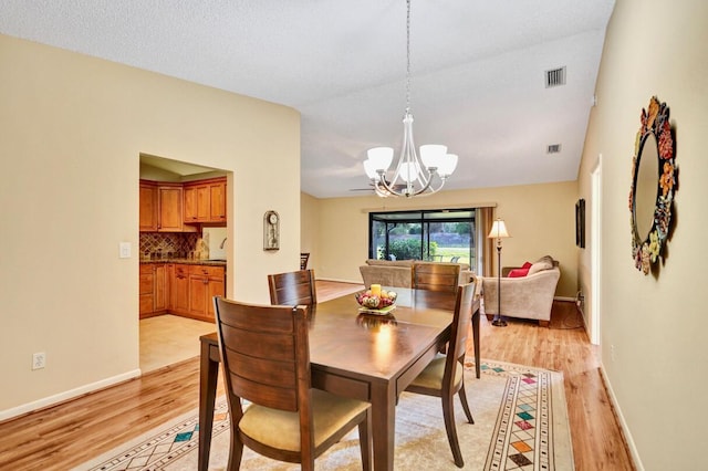 124 Mayfair Ln, Boynton Beach, FL 33426 - dining space featuring light wood-style flooring and a chandelier