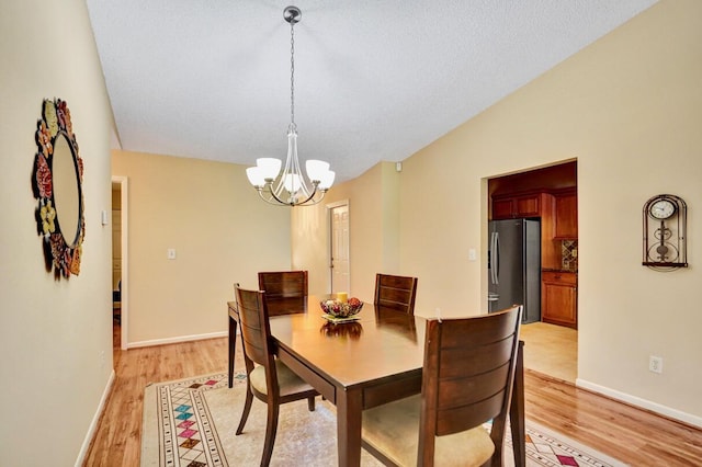 124 Mayfair Ln, Boynton Beach, FL 33426 - dining room with light wood-style flooring and a chandelier