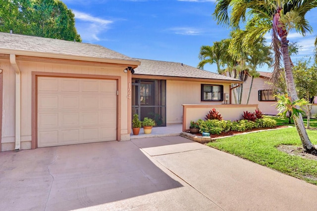 124 Mayfair Ln, Boynton Beach, FL 33426 - ranch-style house featuring an attached garage, driveway, and a front lawn