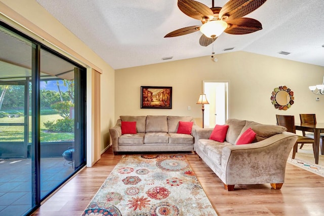 124 Mayfair Ln, Boynton Beach, FL 33426 - living room featuring light wood-style flooring, lofted ceiling, a ceiling fan, a textured ceiling, and a chandelier