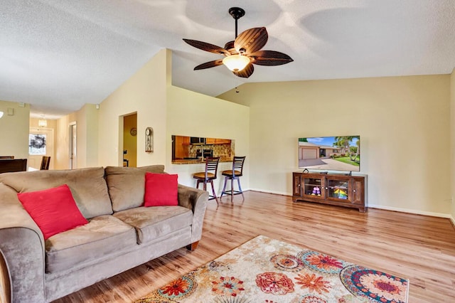 124 Mayfair Ln, Boynton Beach, FL 33426 - living area with lofted ceiling, wood finished floors, ceiling fan, and a textured ceiling
