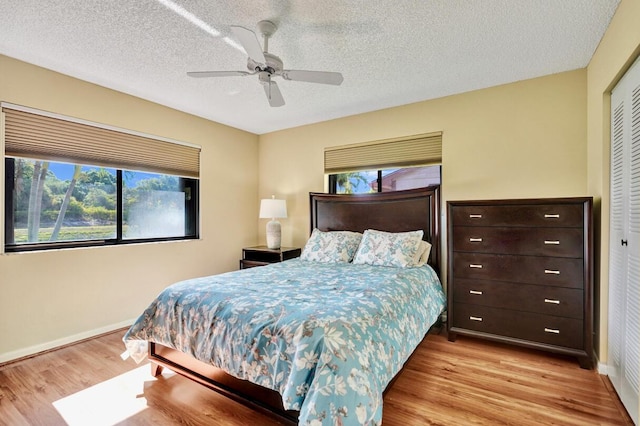 124 Mayfair Ln, Boynton Beach, FL 33426 - bedroom with wood finished floors, a closet, ceiling fan, and a textured ceiling