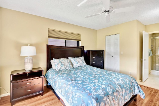 124 Mayfair Ln, Boynton Beach, FL 33426 - bedroom featuring wood finished floors, a closet, a textured ceiling, and a ceiling fan
