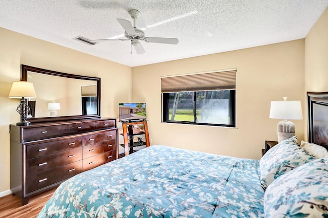 124 Mayfair Ln, Boynton Beach, FL 33426 - bedroom featuring wood finished floors, a ceiling fan, and a textured ceiling