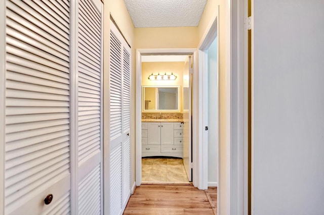 124 Mayfair Ln, Boynton Beach, FL 33426 - hallway with a textured ceiling and light wood finished floors