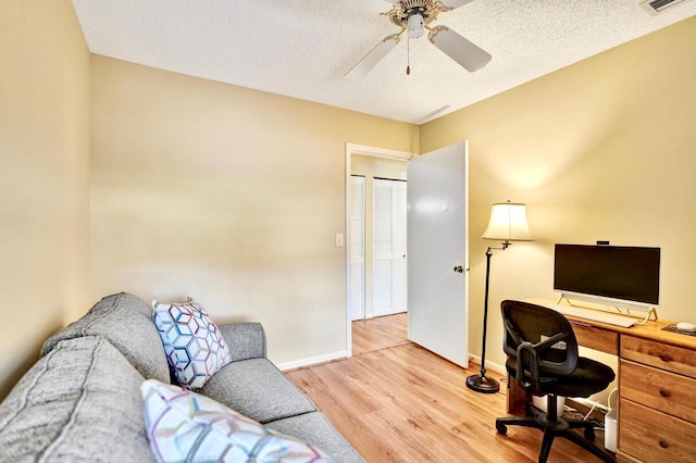 124 Mayfair Ln, Boynton Beach, FL 33426 - office space with light wood-style flooring, a ceiling fan, and a textured ceiling