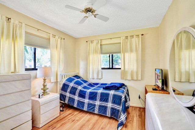 124 Mayfair Ln, Boynton Beach, FL 33426 - bedroom with multiple windows, wood finished floors, a textured ceiling, and ceiling fan