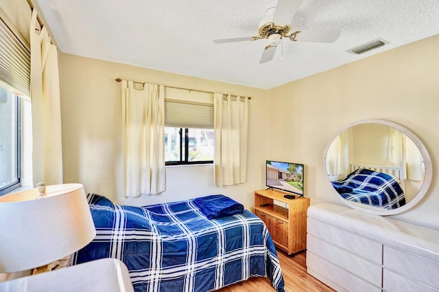 124 Mayfair Ln, Boynton Beach, FL 33426 - bedroom featuring wood finished floors, a textured ceiling, and ceiling fan