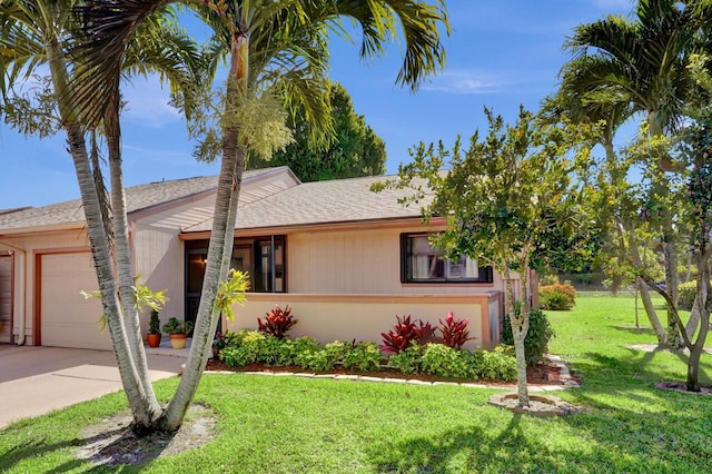124 Mayfair Ln, Boynton Beach, FL 33426 - view of front facade featuring roof with shingles, a front lawn, concrete driveway, and an attached garage