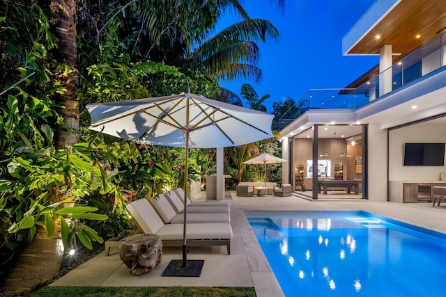 pool with a patio area and an outdoor hangout area