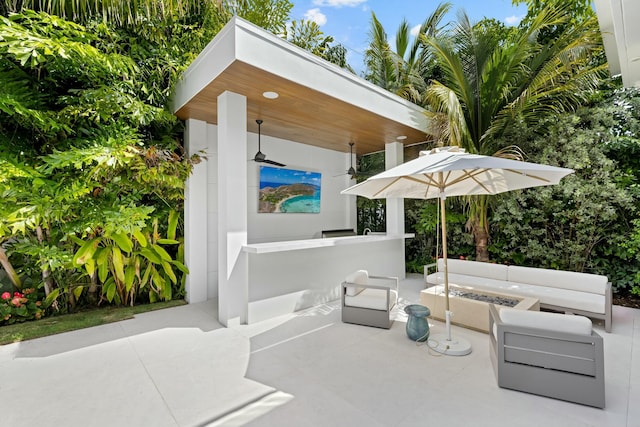 view of patio / terrace featuring an outdoor fire pit and a bar
