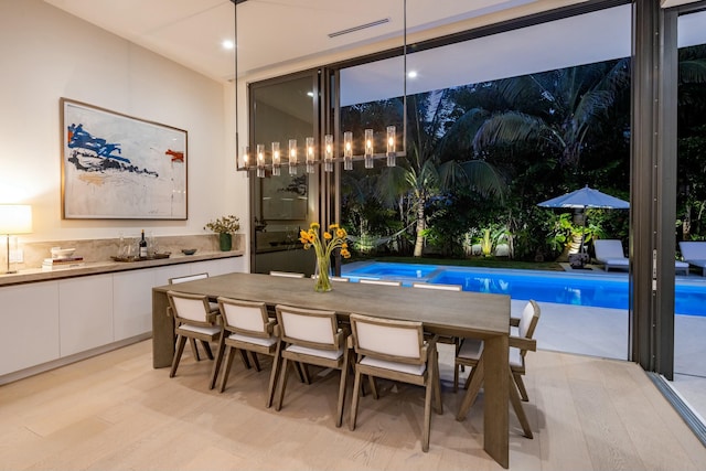 dining room featuring recessed lighting, visible vents, floor to ceiling windows, and light wood-style floors
