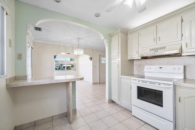 kitchen with light countertops, white electric stove, visible vents, arched walkways, and ventilation hood