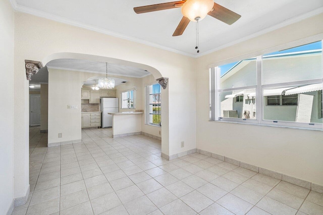 unfurnished room featuring crown molding, light tile patterned floors, and arched walkways