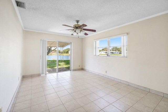 spare room with ceiling fan, a textured ceiling, ornamental molding, visible vents, and a water view