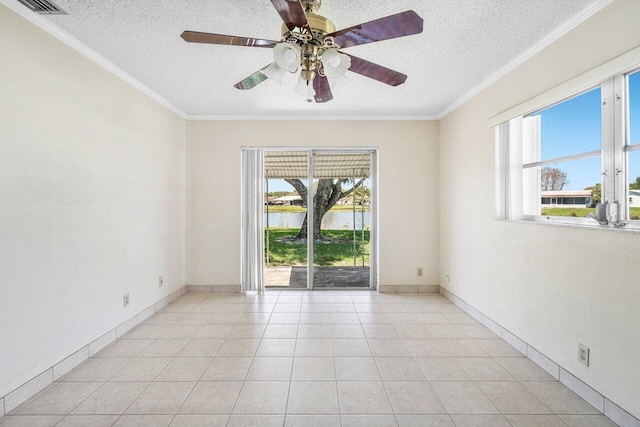 empty room with a ceiling fan, a textured ceiling, and ornamental molding