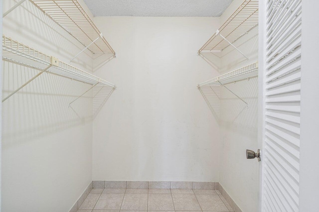 walk in closet featuring light tile patterned flooring
